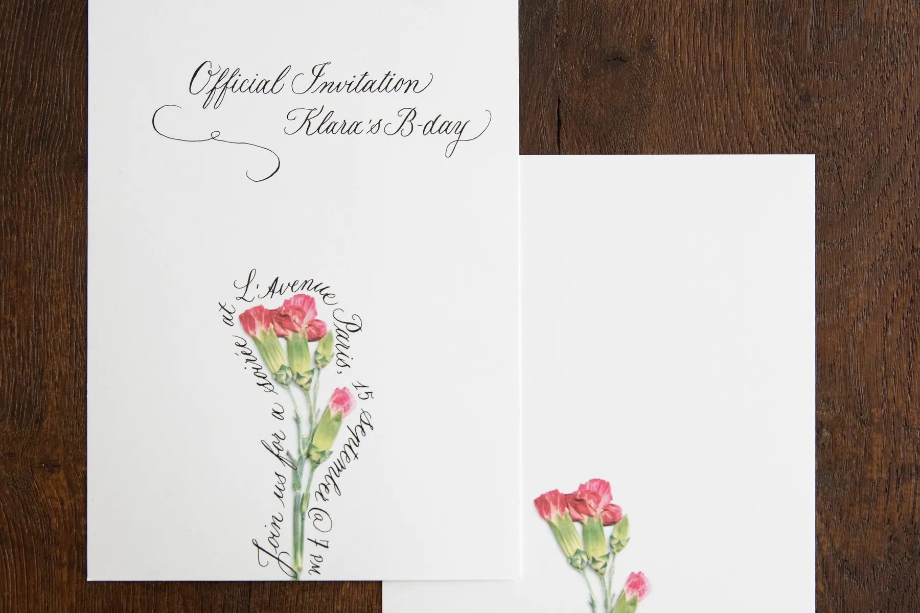 Bespoke Pétalia invitation cards with pressed pink carnations and copperplate calligraphy